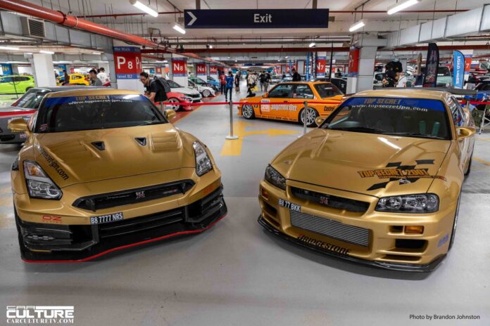 A skyline of legends: GT-Rs, Supras, and widebody supercars lined up in a display of pure power. TOP Secret