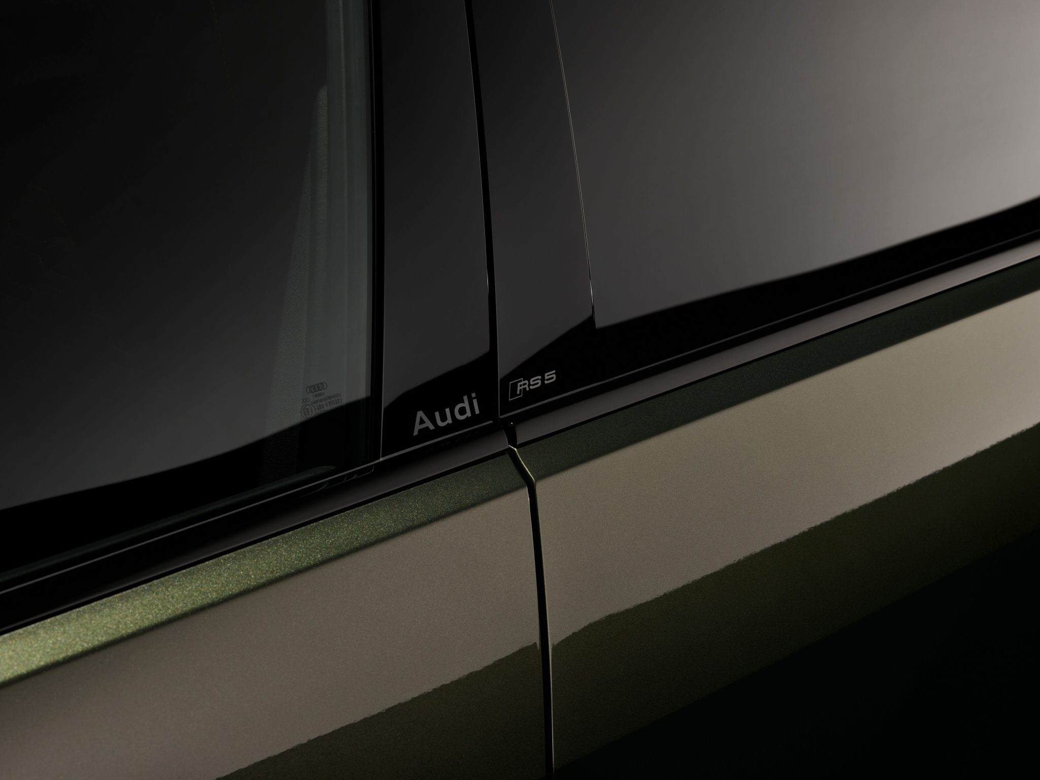 Audi RS5 badge detail on door pillar in low light