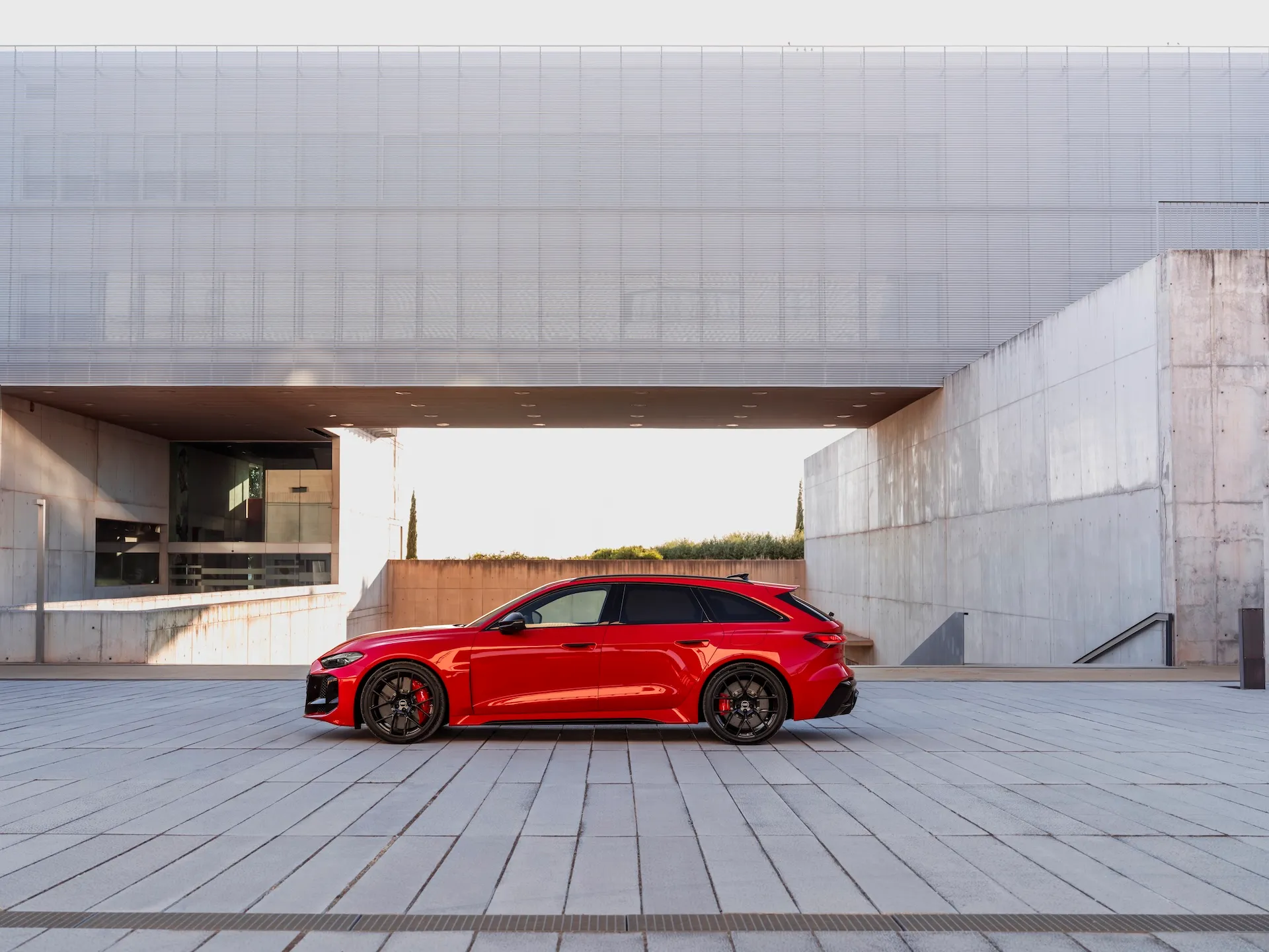 2027 Audi RS5 Avant side profile in contemporary urban plaza