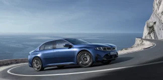 2027 BMW I3 on a mountain road 3 quarter view