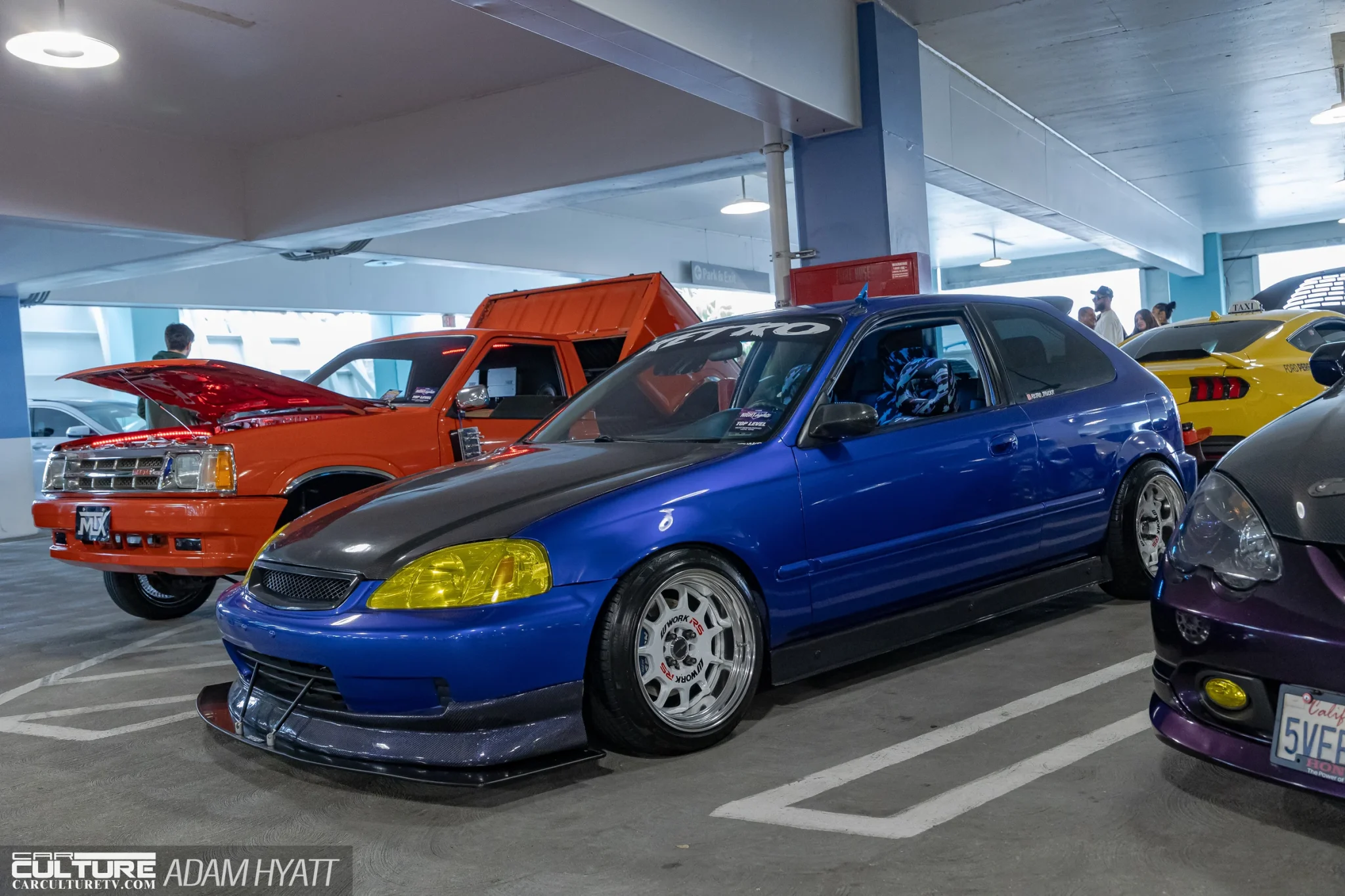 blue EG Civic hatchback on Work wheels with a carbon hood and yellow tinted headlights