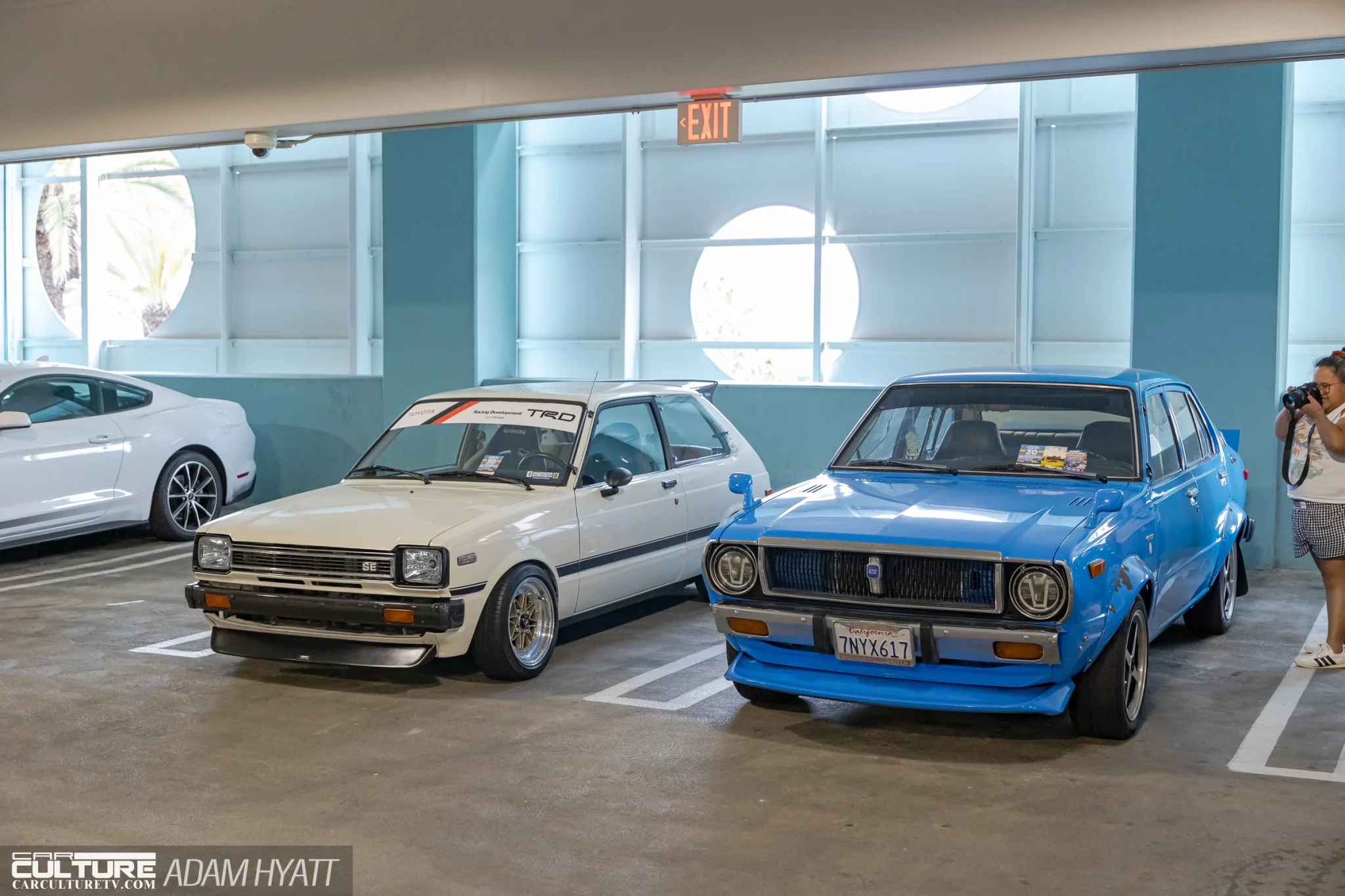 white Toyota Starlet and a blue Datsun 1200 sedan