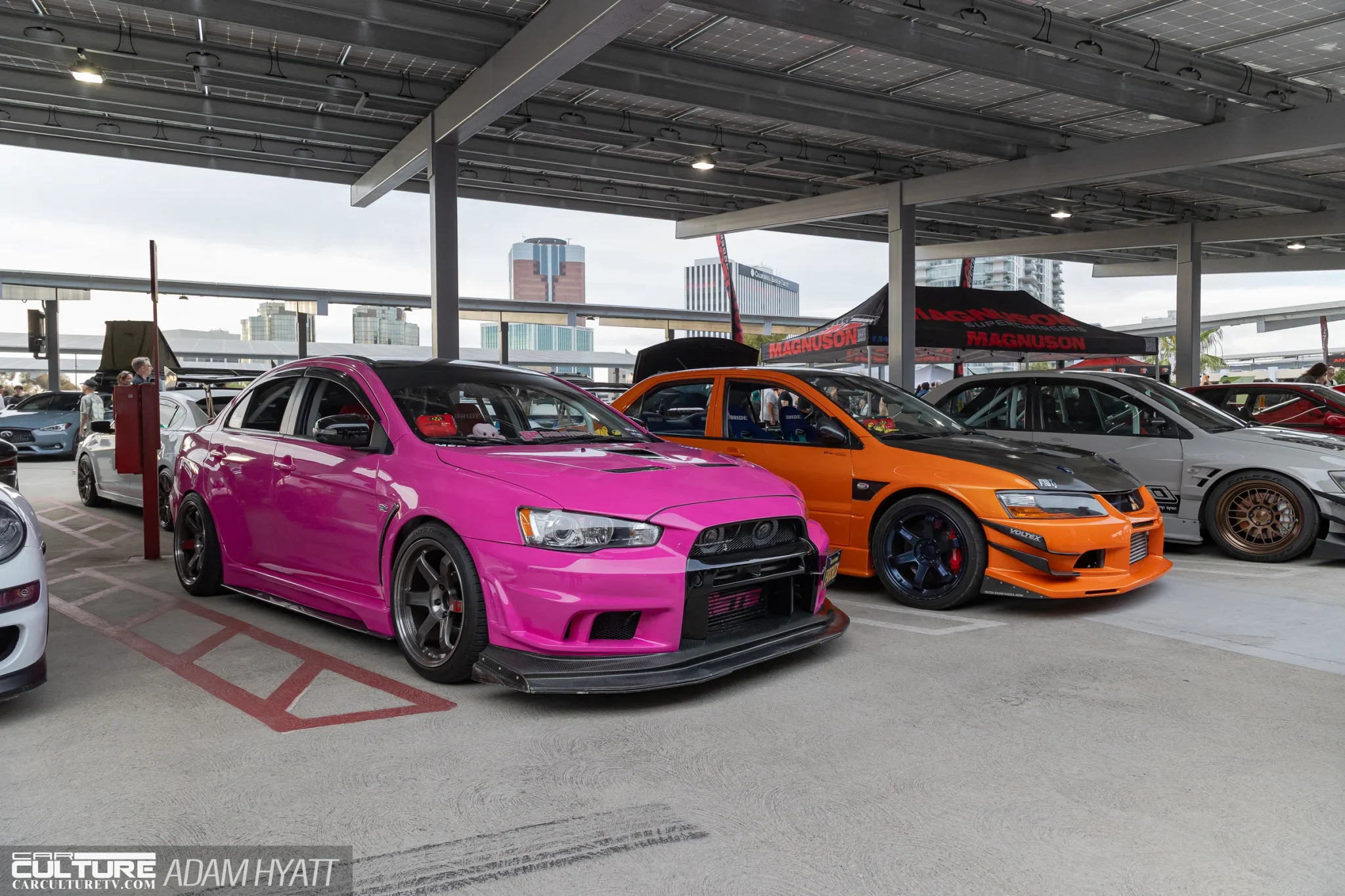 A pink Evo X and an orange Evo VIII